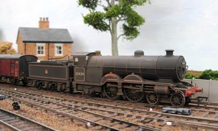 A model train on tracks

Description automatically generated