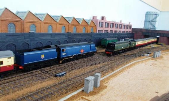 An unlikely photograph for a  real  Ewhurst Green. However, one of the joys of running sessions permits visiting early BR Blue liveried Merchant Navy 35024 'East Asiatic Company' to pass BR Green liveried 35011  General Steam Navigation ; the latter being a recent metal-bodied release under the Hornby-Dublo brand (albeit in lined blue  3-rail  packaging).