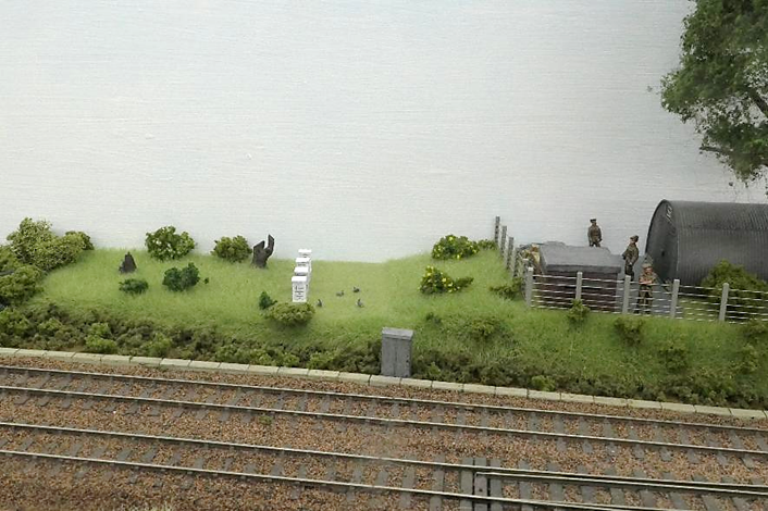 There are a number of bee hives dotted around the layout; these being on railway land. With very few people entering this area rabbits freely run around. 
To the left are a number of tree stumps from the trees felled to provide sightlines for the adjacent ROF brick pill box.
www.EwhurstGreen.com
