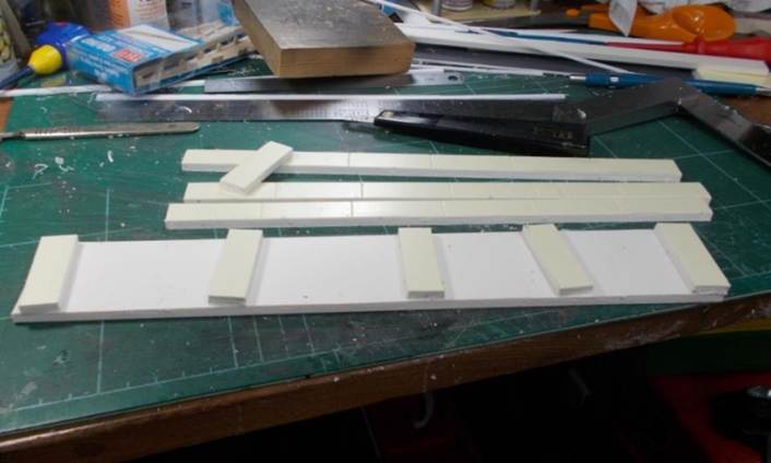 Resting upside-down on the bench, the platform construction uses three layers of 5mm foamboard thence another 3mm to bring it up to the correct height for its plasticard surface.
www.EwhurstGreen.com  
