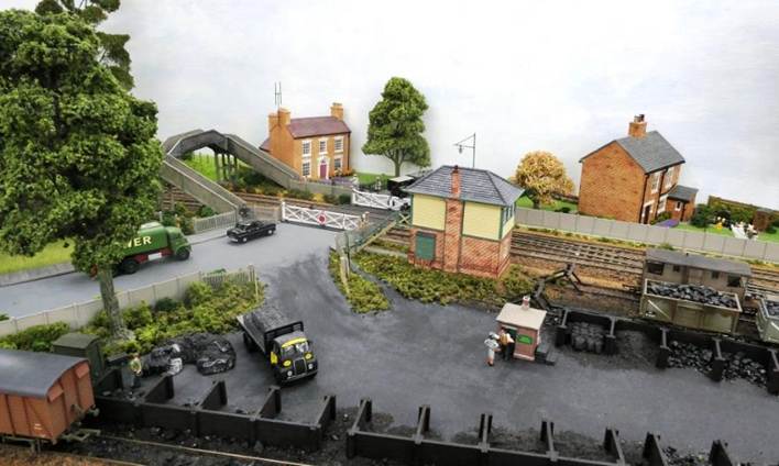 With modernisation of the signalling, Hornby s  Horsted Keynes  Signalbox was delegated to the role of a crossing box. Buffer stops are LBSCR-type from Lanarkshire Model Supplies.
An angry customer remonstrates with the Coal Merchant as the Signalman looks on at the commotion.
www.EwhurstGreen.com  
