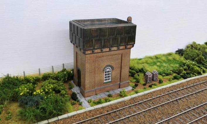 LBSCR water tank.
Adjacent to the tank, a member of railway staff has set up some bee-hives - something no longer seen lineside.
www.EwhurstGreen.com 
